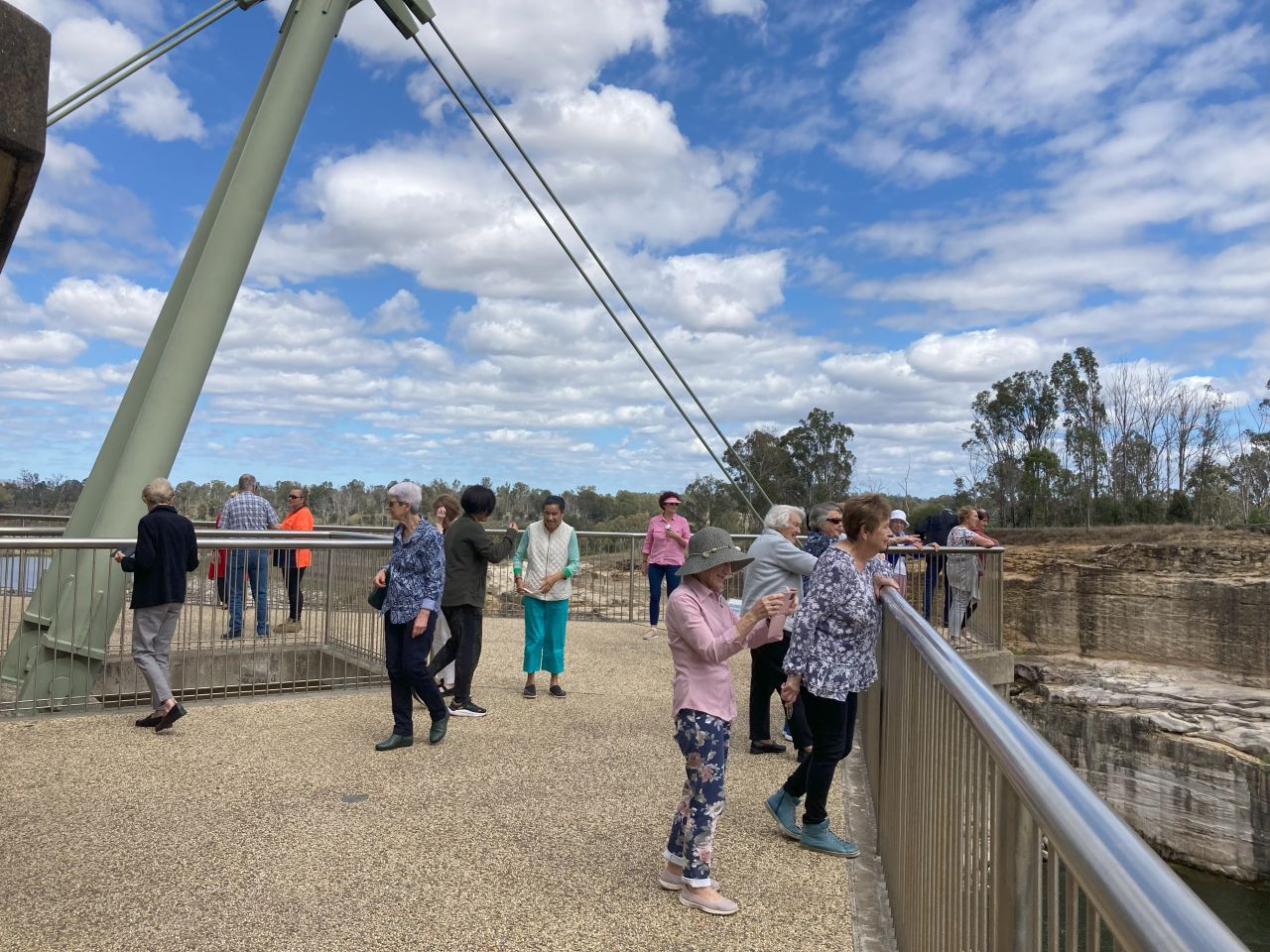Members and guests enjoy a view of the Wivenhoe Dam spillway during  a day bus trip in September 2023