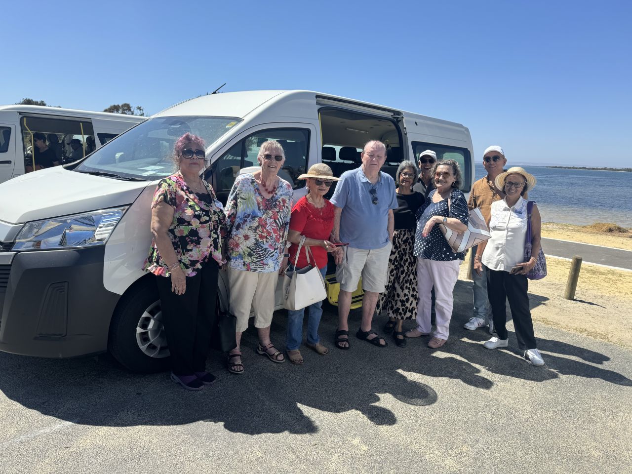 Perth Members with their bus at Seba the Song Giant from L-R Mina Crasto, Elizabeth Simionato, Terri and Rod MacLaren, Melanie Fonseca, Philip Goes, Genie Bristowe, Lawrence Minus (Bus Driver) and Melody Correia (Bus Leader)